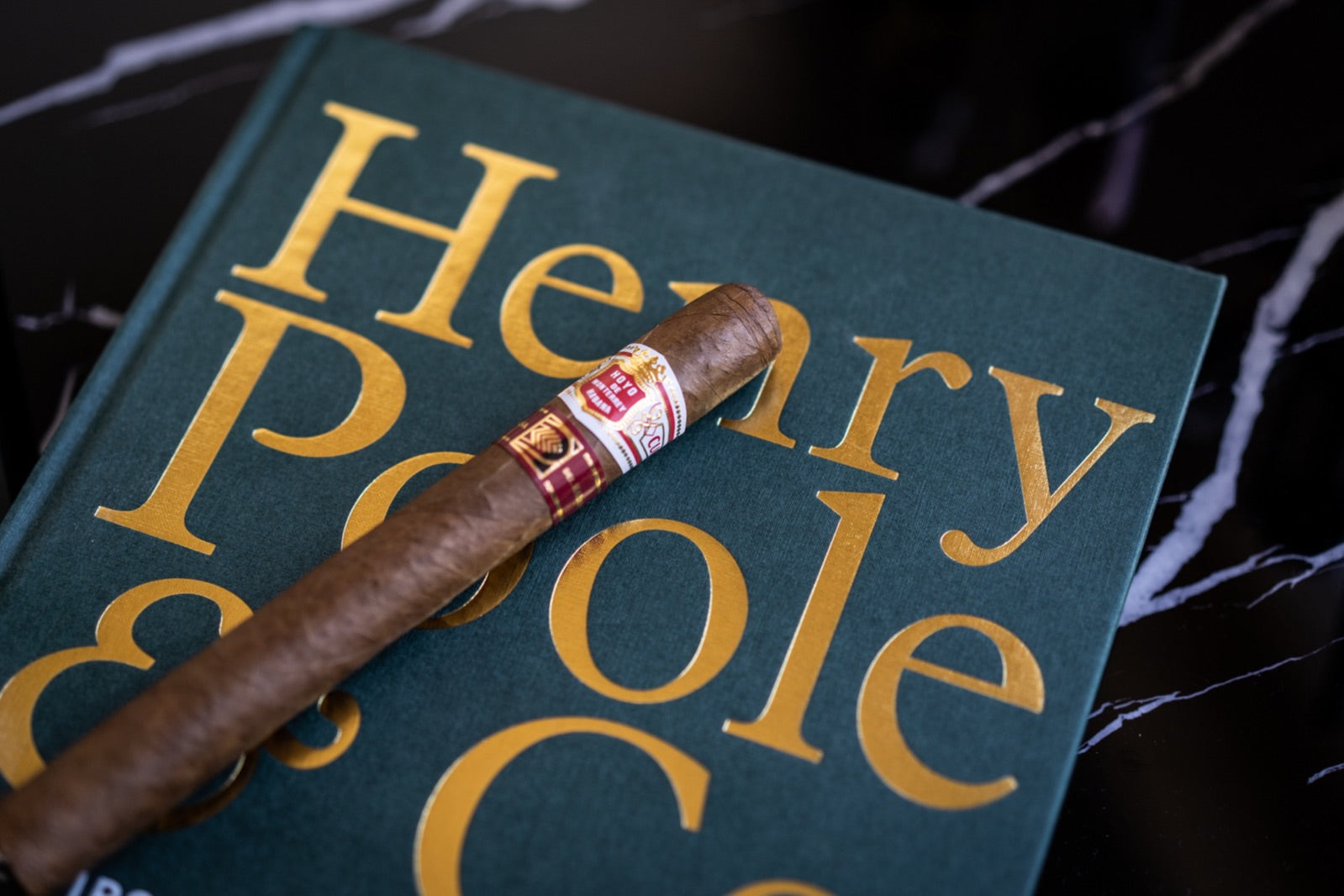 Aged Havana cigar resting on a crystal ashtray beside a 14-year single malt whisky, illustrating the art of ageing cigars