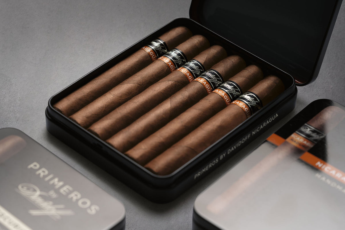 Primeros by Davidoff tins and cigars arranged on a dark surface